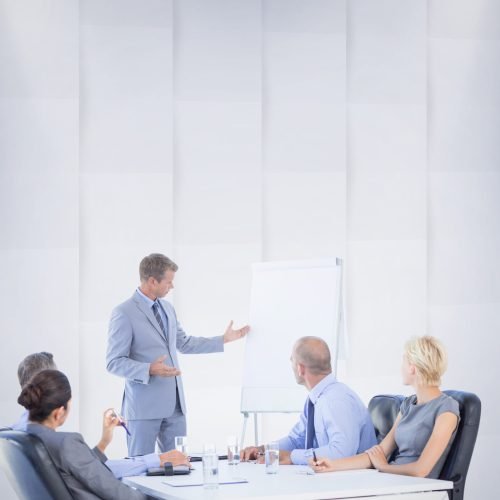 Business people listening during meeting against abstract background