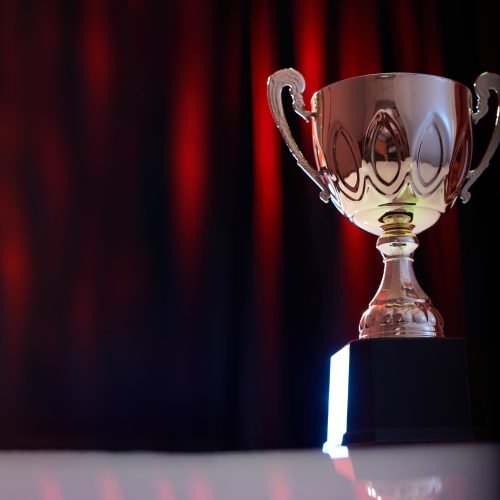 trophy against stage red light on curtain as background
